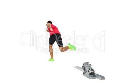 Male athlete running from starting blocks