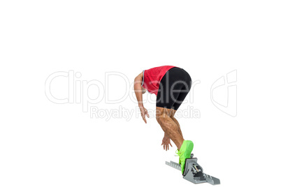 Male athlete running from starting blocks