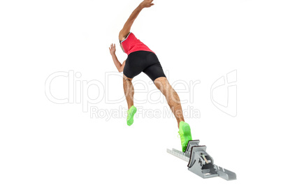 Male athlete running from starting blocks