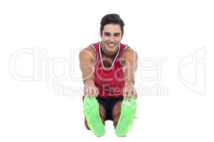 Portrait of male athlete doing stretching exercise