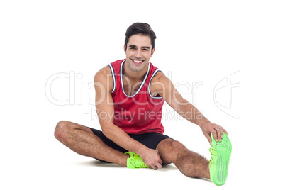 Portrait of male athlete stretching his hamstring