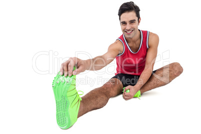 Portrait of male athlete doing stretching exercise