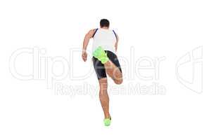 Rear view of male athlete running on white background