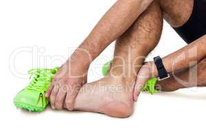 Male athlete with foot pain on white background