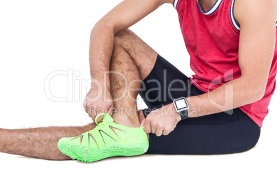 Male athlete wearing his sport shoes and getting ready for sport