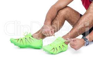 Male athlete tying his running shoes