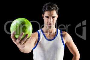 Portrait of happy male athlete holding a ball