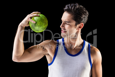 Happy male athlete holding a ball