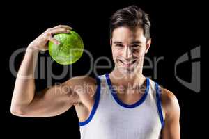 Portrait of happy male athlete holding a ball