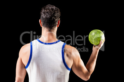 Rear view of male athlete holding ball Rear view of male athlete holding ball