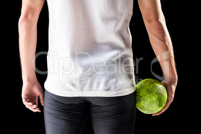 Mid section of athlete man holding ball