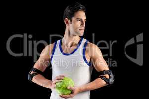 Confident athlete man holding a ball