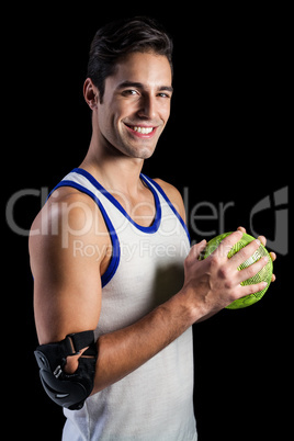 Portrait of happy athlete man holding a ball