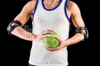 Mid section of athlete man holding ball