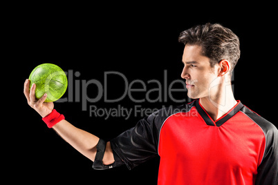Confident athlete man holding a ball