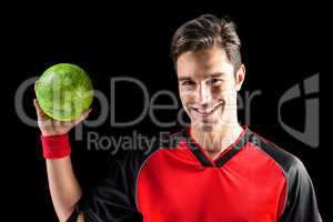 Portrait of happy athlete man holding a ball