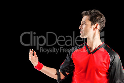 Confident athlete man posing on black background