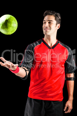 Confident athlete man playing with a ball