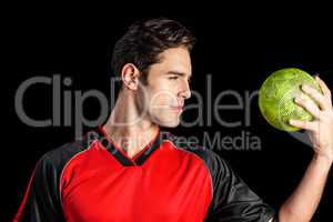 Confident athlete man holding a ball