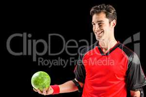 Happy athlete man holding a ball