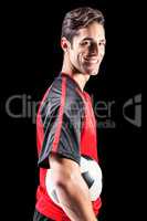 Portrait of happy male athlete holding football