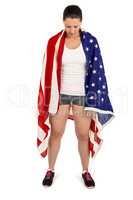Female athlete with american flag wrapped around her body