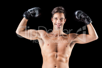 Portrait of happy boxer showing muscles