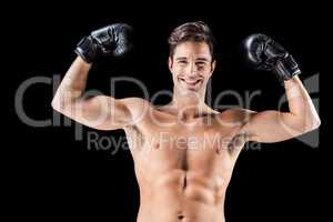 Portrait of happy boxer showing muscles