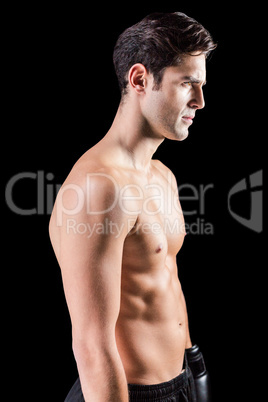 Side view of boxer standing on black background