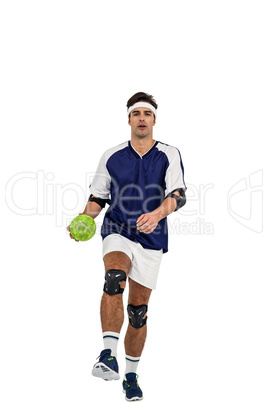 Sportsman posing with ball on white background