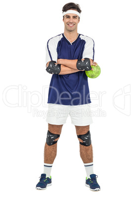 Sportsman standing with ball on white background