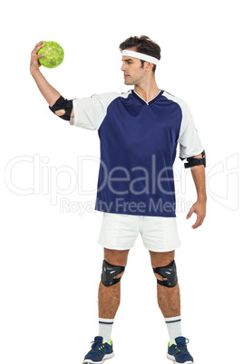 Sportsman posing with ball on white background