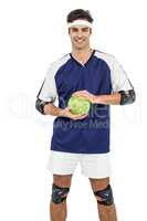 Sportsman standing with ball on white background