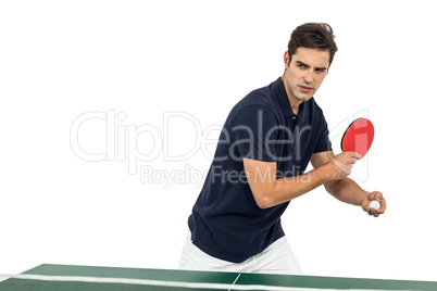 Confident male athlete playing table tennis