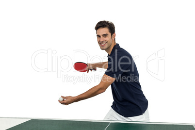 Portrait of happy male athlete playing table tennis