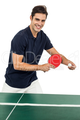 Portrait of male athlete playing table tennis