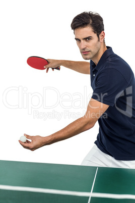 Confident male athlete playing table tennis