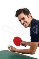 Portrait of happy male athlete playing table tennis
