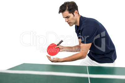 Confident male athlete playing table tennis