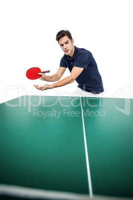 Confident male athlete playing table tennis