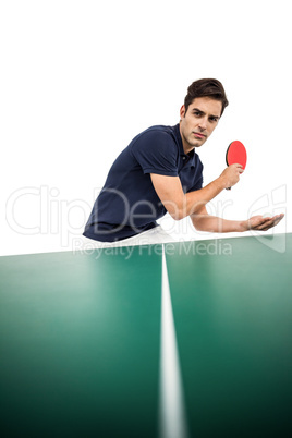 Confident male athlete playing table tennis