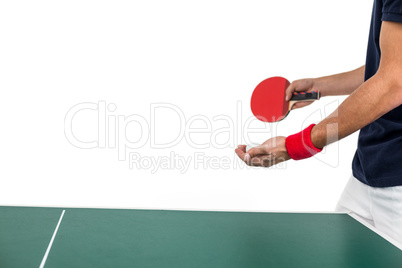 Mid section of athlete man playing table tennis