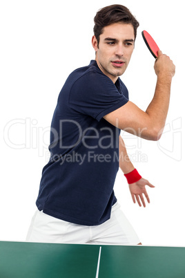 Confident male athlete playing table tennis