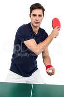 Confident male athlete playing table tennism