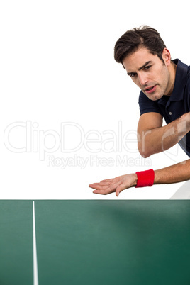 Confident male athlete playing table tennis