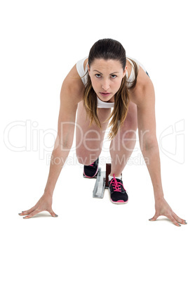 Portrait of athlete woman in ready to run position