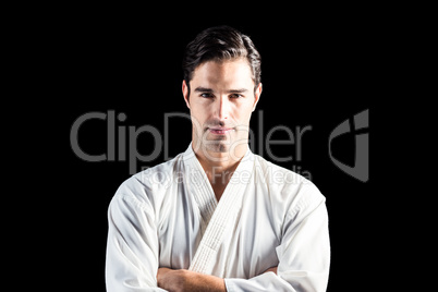 Portrait of fighter standing on black background