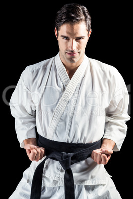 Portrait of fighter performing karate stance