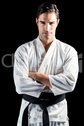 Portrait of fighter standing on black background