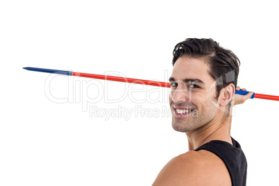 Portrait of happy male athlete holding javelin